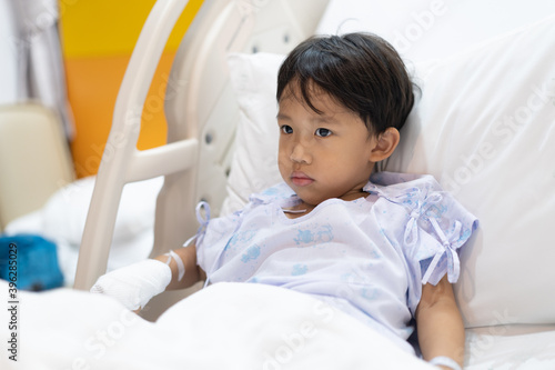 A patient boy is a sick flu in the hospital, He has a cheerful heart.