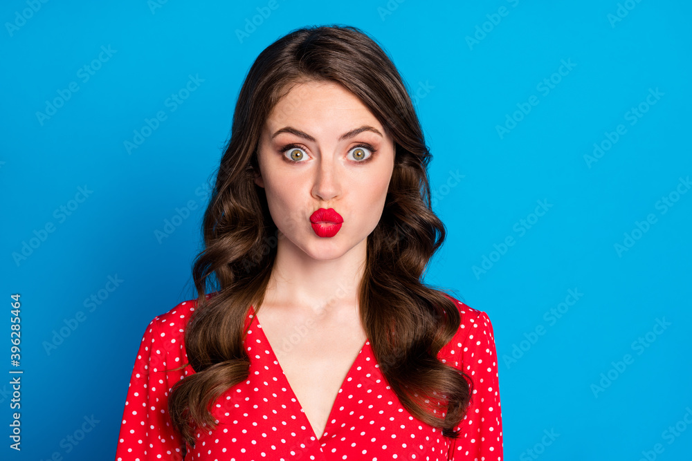 Portrait of young beautiful shocked amazed surprised girl pout red lips look camera isolated on blue color background Portrait of young beautiful shocked amazed surprised girl pout red lips look camera isolated on blue color background