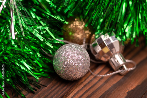 Shiny balloons and colorful tinsel elements of Christmas tree decoration, Close-up, selective focus. New year and Christmas.