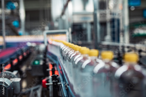 Wallpaper Mural Bottling factory - Juice bottling line for processing and bottling lemon juice into bottles. Selective focus. Torontodigital.ca