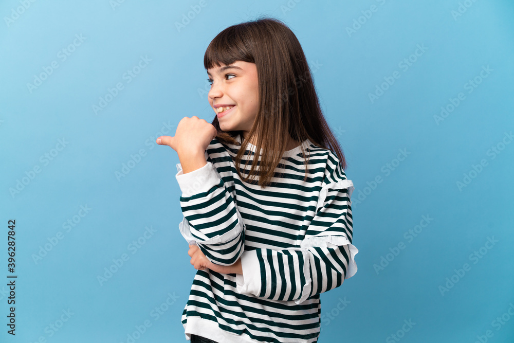 Little girl over isolated background pointing to the side to present a product Little girl over isolated background pointing to the side to present a product