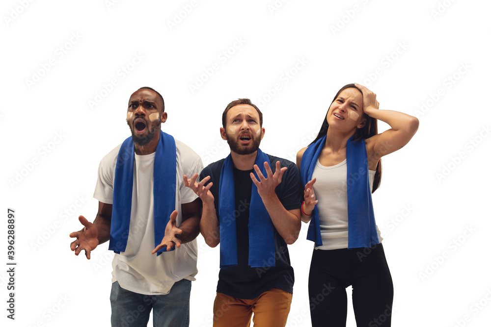 Obraz premium Sad. Multiethnic soccer fans cheering for favourite team with bright emotions isolated on white background. Beautiful caucasian women look excited, supporting. Concept of sport, fun, support.