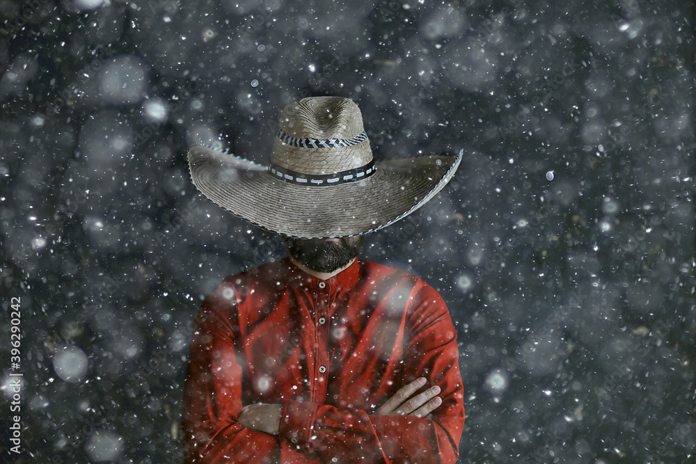 Obraz premium man in sombrero hat with brim, mexican style, latin america, snow cold winter christmas background