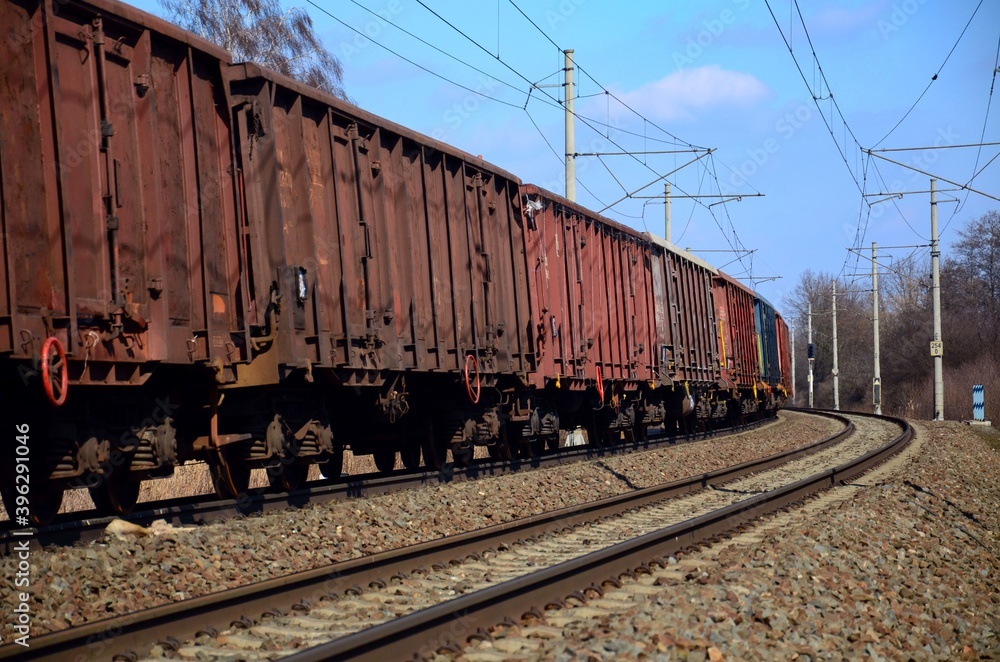 Fototapeta premium Freight railway cars running on electrified railway track, Czech Republic, Europe.