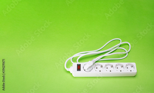 extension cable with many different DC USB output ports. on a green background. Copy space