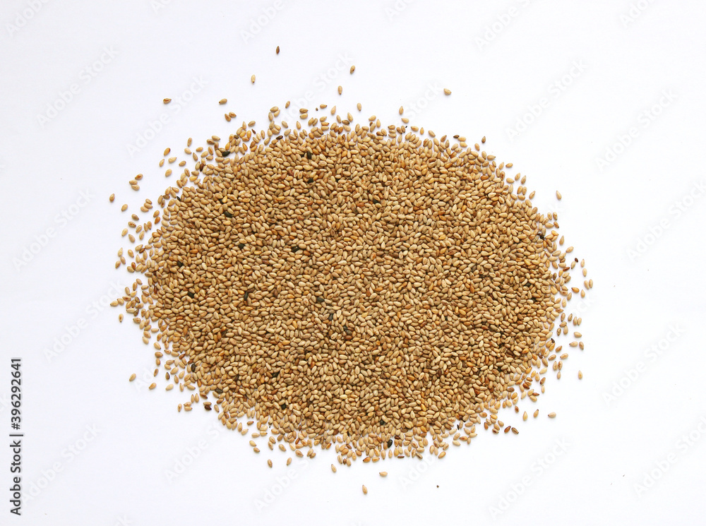 Heap of organic natural sesame seeds over isolated on white background Heap of organic natural sesame seeds over isolated on white background