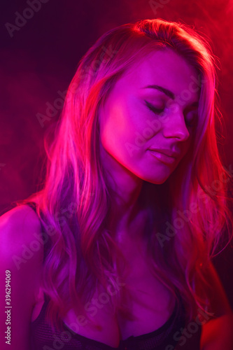 young woman under colored light