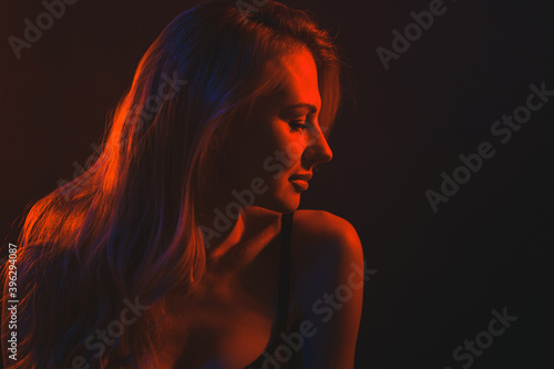 young woman under colored light