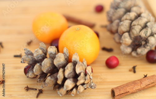 Christmas Gift on Old Wood Background. Spices, tangerines and cones. Kitchen in Christmas time. Gift cards. Calendar page. December. 