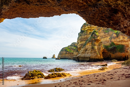 Natural caves and beach, Algarve Portugal. Rock cliff arches of Seven Hanging Valleys and turquoise sea water on coast of Portugal in Algarve region © Kotangens