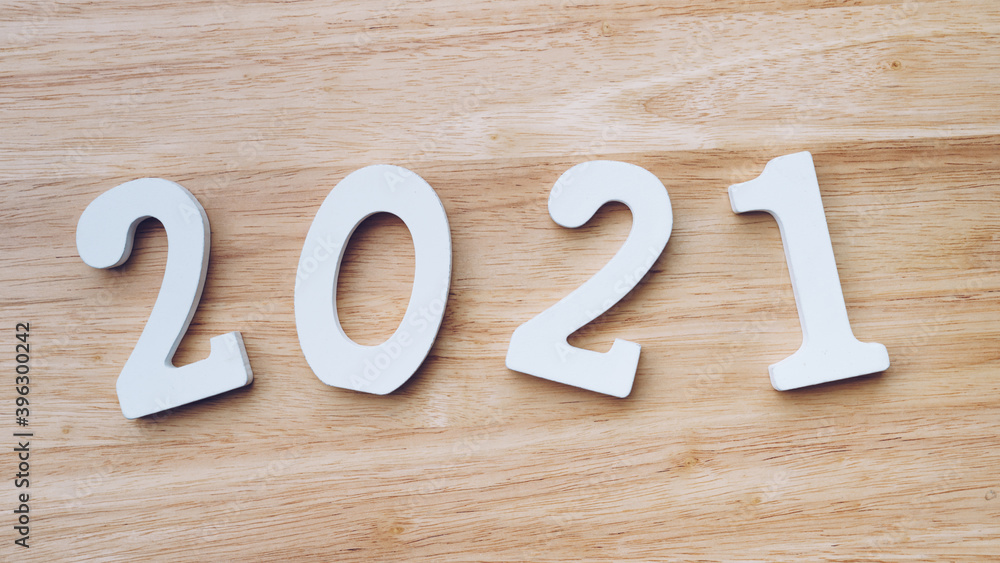 Business and design concept - wooden number 2021 for Happy new year text on wood table. Business and design concept - wooden number 2021 for Happy new year text on wood table.