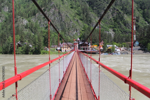Photography red bridge across the katun river in mountain altai