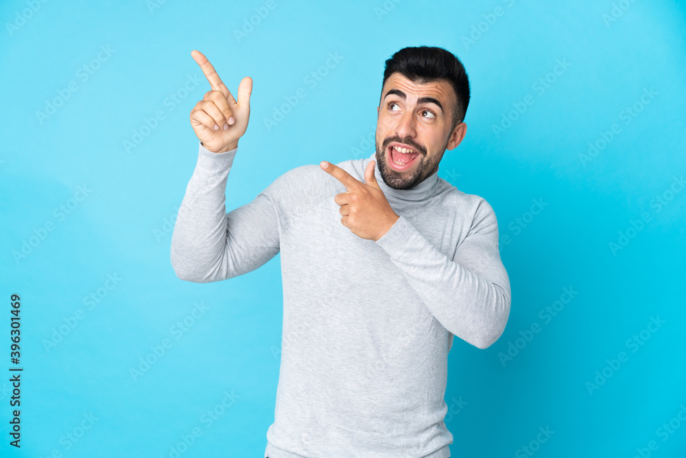 Caucasian man over isolated blue background pointing with the index finger a great idea Caucasian man over isolated blue background pointing with the index finger a great idea