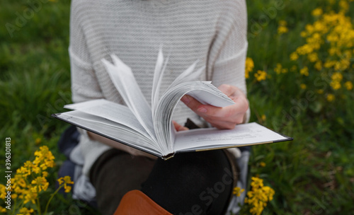 girl reading a book in nature