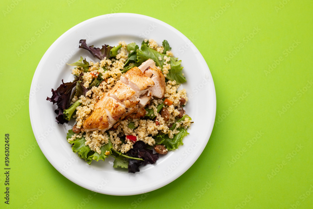 chicken with vegetables and quinoa on dish on green background chicken with vegetables and quinoa on dish on green background