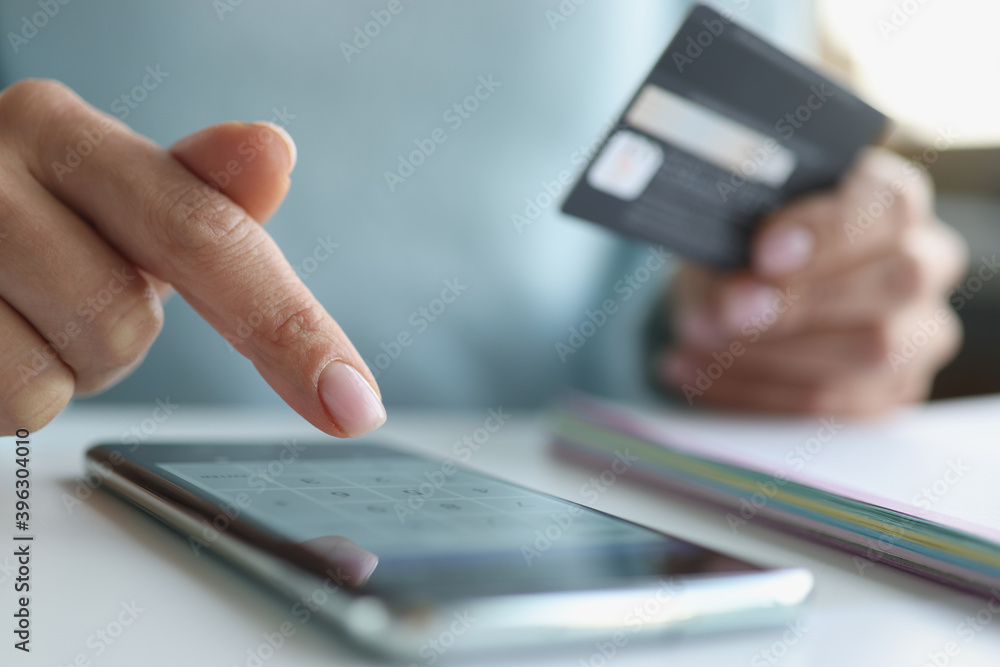 Fototapeta premium Woman makes online payments through smartphone closeup