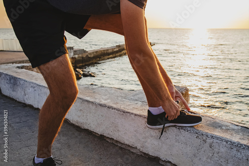 Man preparing for jogging near the sea at the morning.