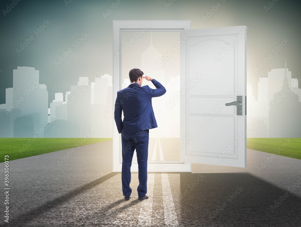 Businessman in front of door in business opportunities concept Businessman in front of door in business opportunities concept