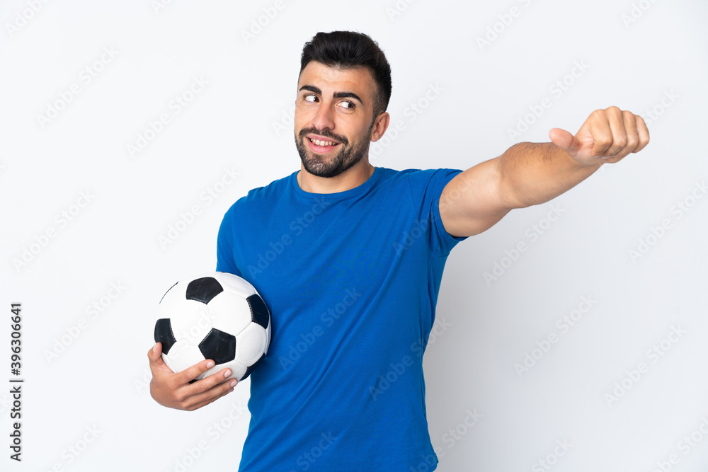 Handsome young football player man over isolated wall giving a thumbs up gesture Handsome young football player man over isolated wall giving a thumbs up gesture