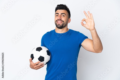 Handsome young football player man over isolated wall showing ok sign with fingers