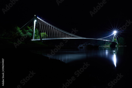 Night photo of a bridge over a water surface
