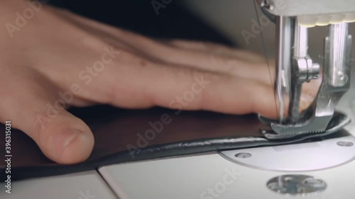 Man sews a line on a sewing machine