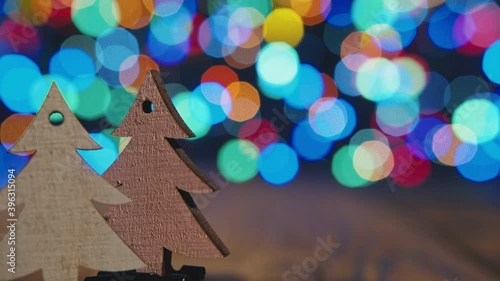 Christmas background with fir-tree wooden ornament. Twq tiny woode fir tree on bokeh backgound with place ror inscriptions. photo