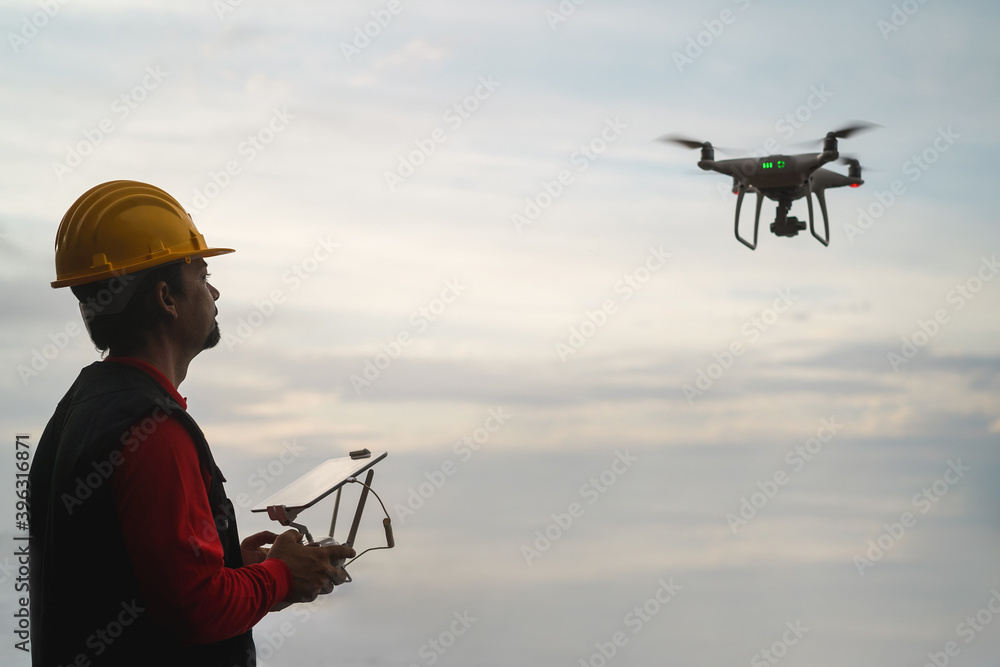 Man engineer pilot flying with drone - Video surveillance and industrial inspection concept Man engineer pilot flying with drone - Video surveillance and industrial inspection concept