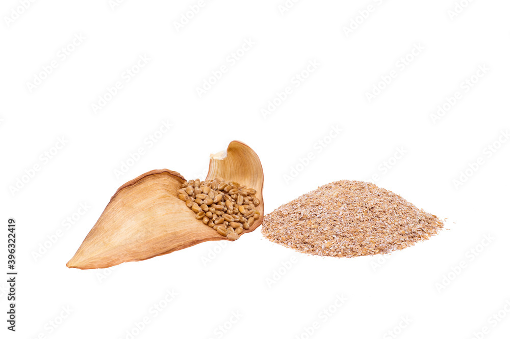 Wheat grains on a dry corn leaf with a handful of wheat bran cut on a white background Wheat grains on a dry corn leaf with a handful of wheat bran cut on a white background