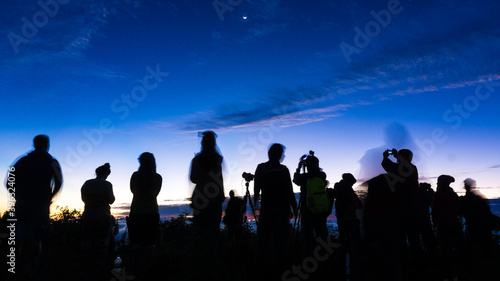Group of silhouette happy travel friends on background of sunset or sunrise high mountain