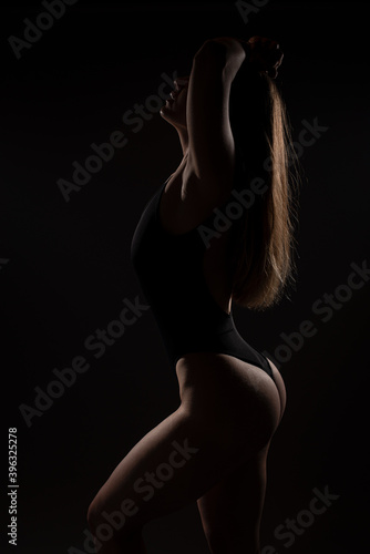 Sexy girl posing in studio on grey background. Isolated © Bogdan