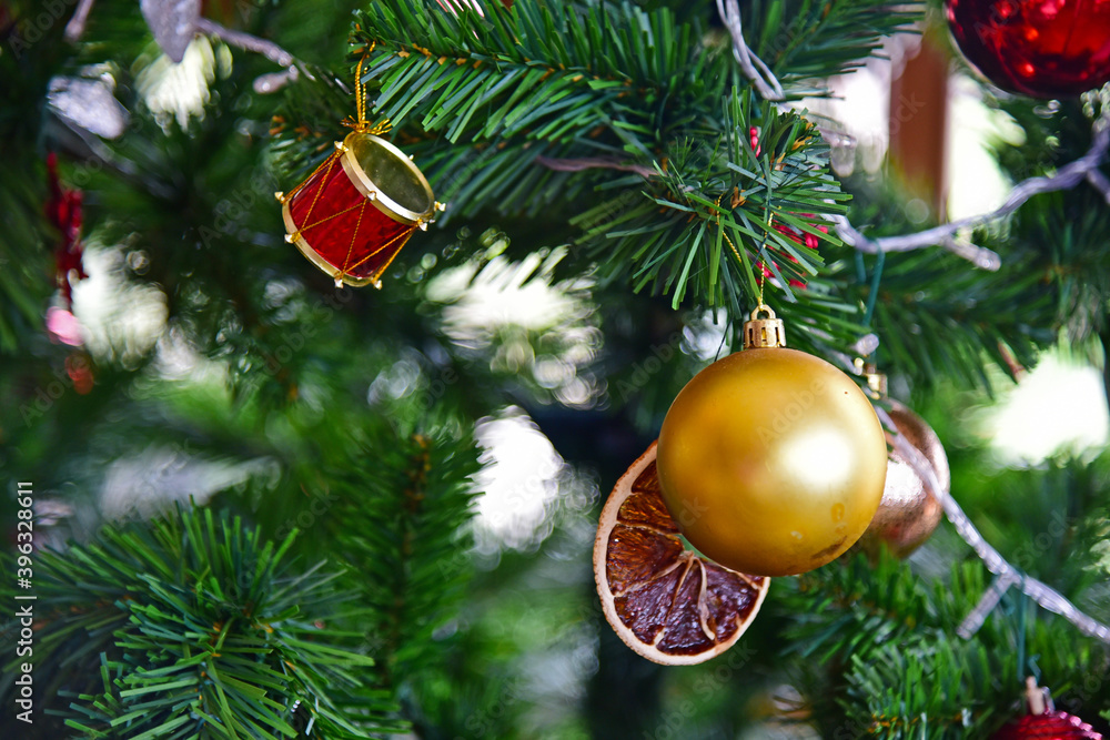 Close up gold ball and toys decorating the chrismas tree. Close up gold ball and toys decorating the chrismas tree.