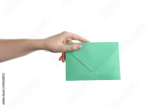 Woman holding green paper envelope on white background, closeup photo