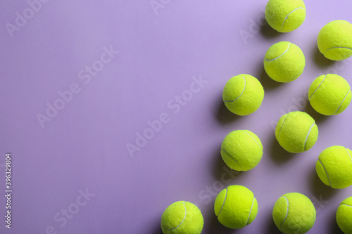 Tennis balls on violet background, flat lay. Space for text © New Africa