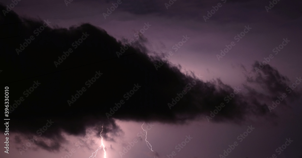 Fototapeta premium Panorama with many bright lightning discharges from the big black stormy cloud on the gloomy rainy sky