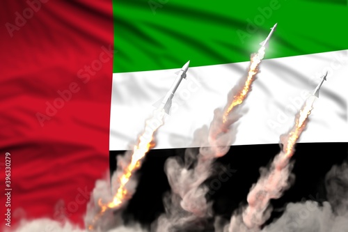 United Arab Emirates nuclear warhead launch - modern strategic nuclear rocket weapons concept on flag fabric background, military industrial 3D illustration with flag photo