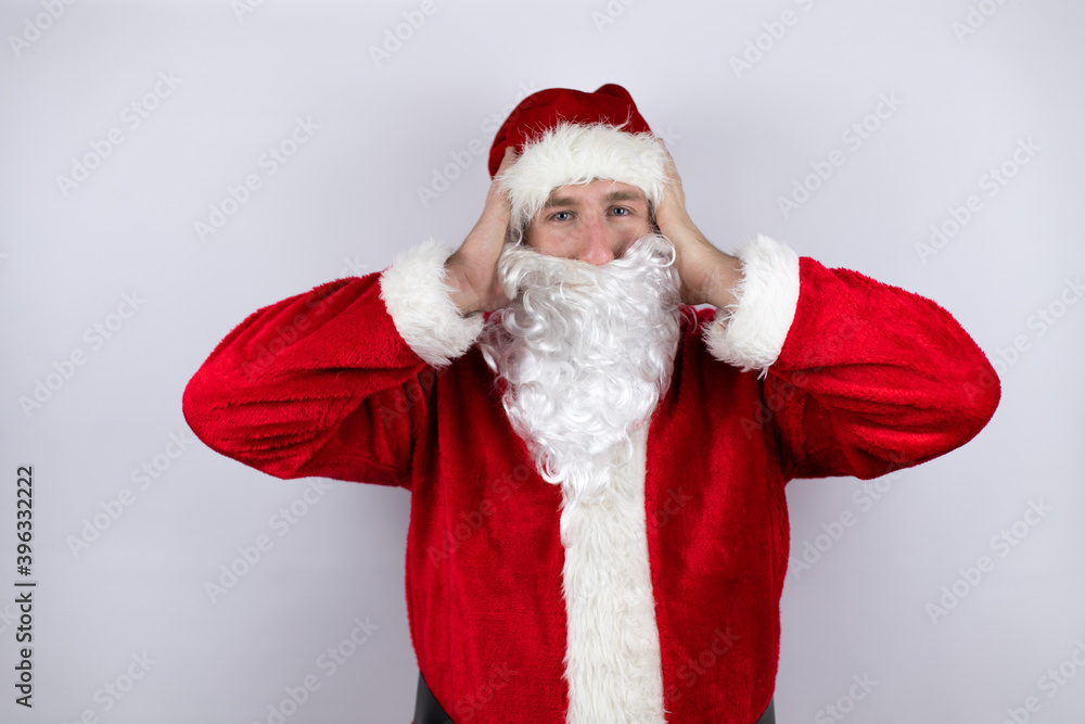 Man dressed as Santa Claus standing over isolated white background thinking looking tired and bored with hands on head Man dressed as Santa Claus standing over isolated white background thinking looking tired and bored with hands on head