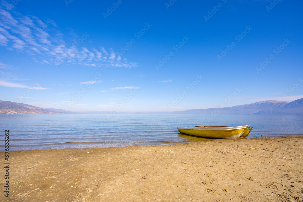 Wooden boats at pier on mountain lake