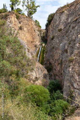 HaTanur waterfall flows from a crevice in the mountain and is located in the continuation of the rapid, shallow, cold mountain Ayun river in the Galilee in northern Israel