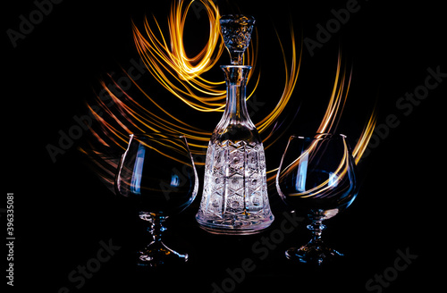 Glass luxury bottle with light painting and old style of drinking a fresh drink