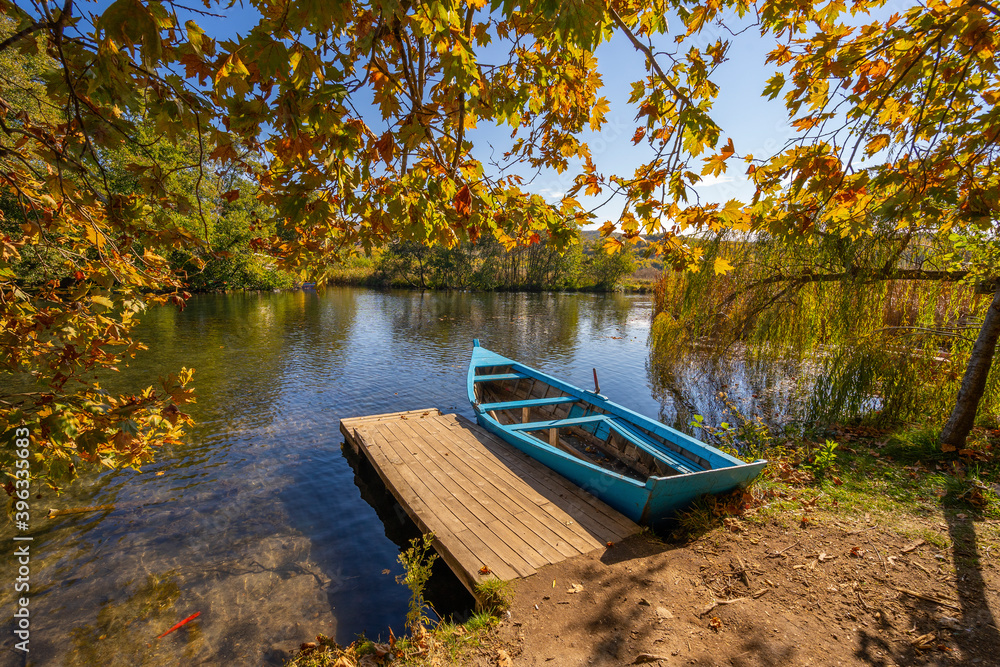 Wooden boat at pier on beautiful lake