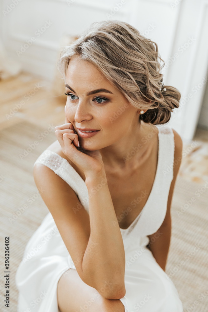 portrait of a beautiful blonde woman close up. A woman in a white dress looking at the camera. portrait of a beautiful blonde woman close up. A woman in a white dress looking at the camera.