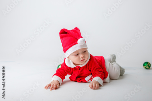 a baby in a Santa Claus costume on a white background
