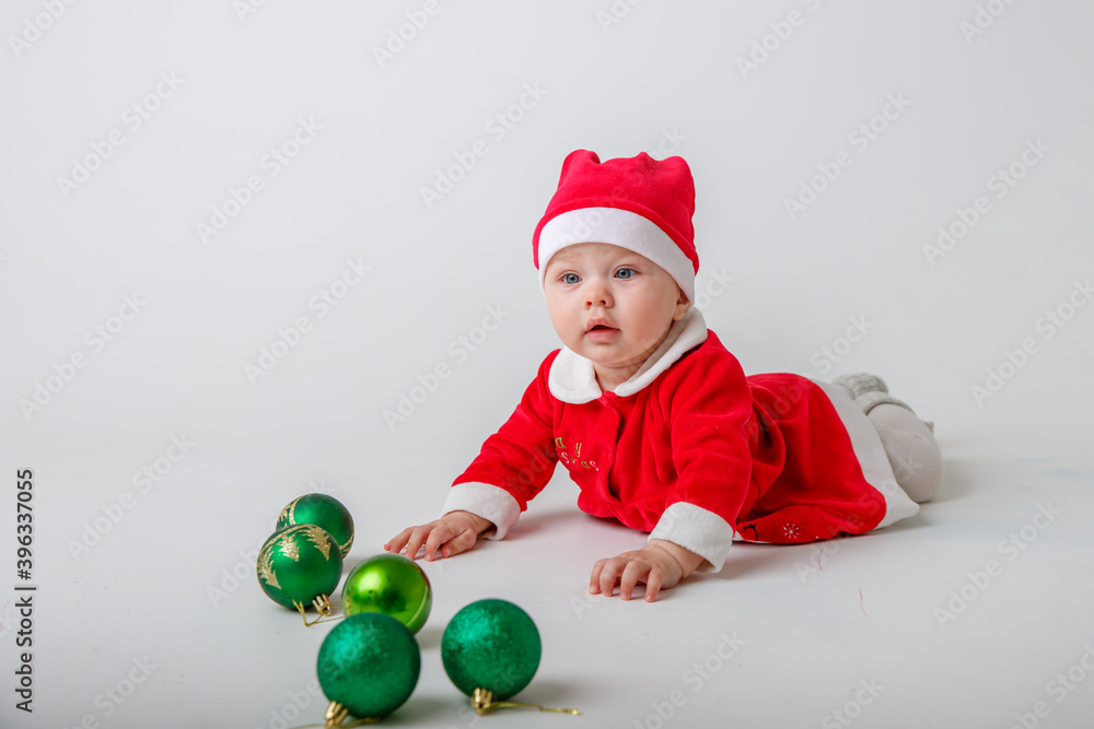 a baby in a Santa Claus costume on a white background a baby in a Santa Claus costume on a white background