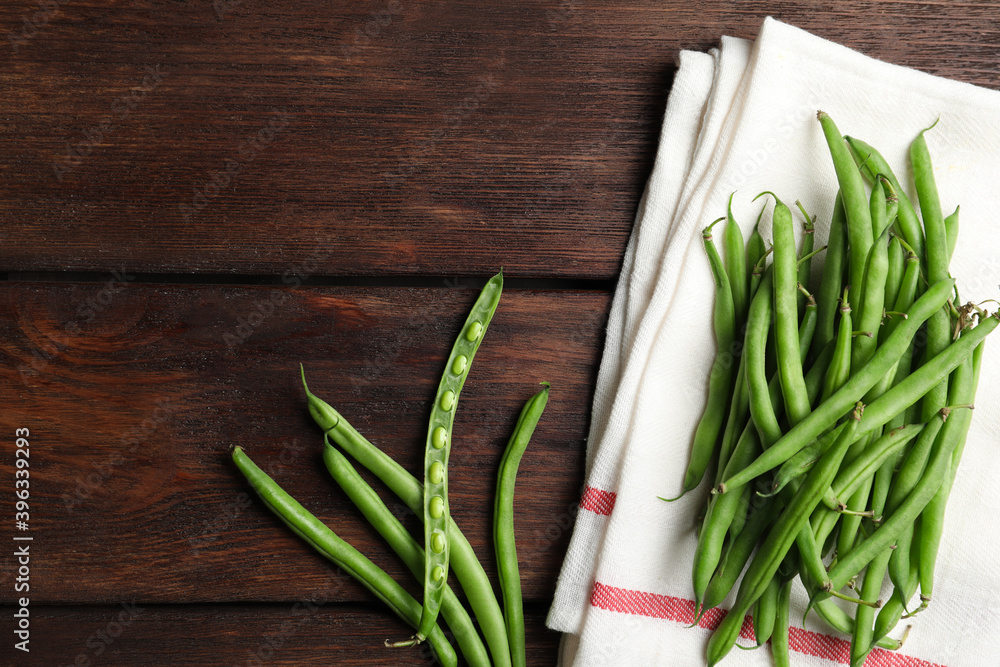 Fresh green beans on wooden table, flat lay. Space for text Fresh green beans on wooden table, flat lay. Space for text