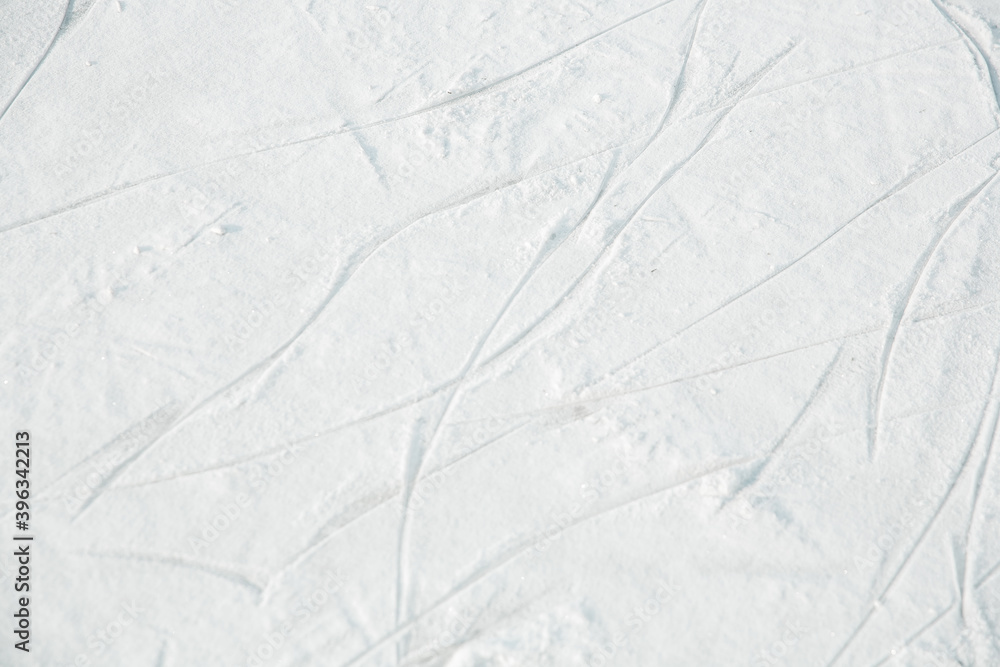 Obraz premium Ice Rink Texture with traces of ice skating. Selective focus of Skate marks on the ice.