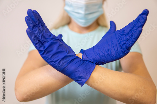 paramedic in a mask from coronavirus holding hands in the cross