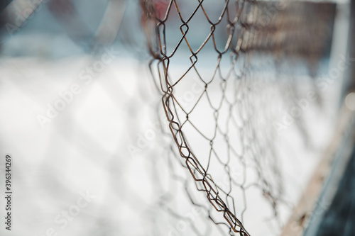 chain link fence. wire mesh fence with snow on blurred background