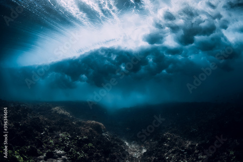 Breaking wave with foam and bubbles underwater. Transparent water