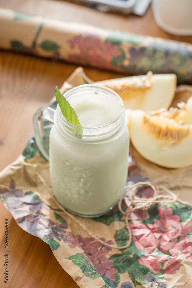 healthy smoothie with mint in glass mason jar on wooden table at cafe healthy smoothie with mint in glass mason jar on wooden table at cafe